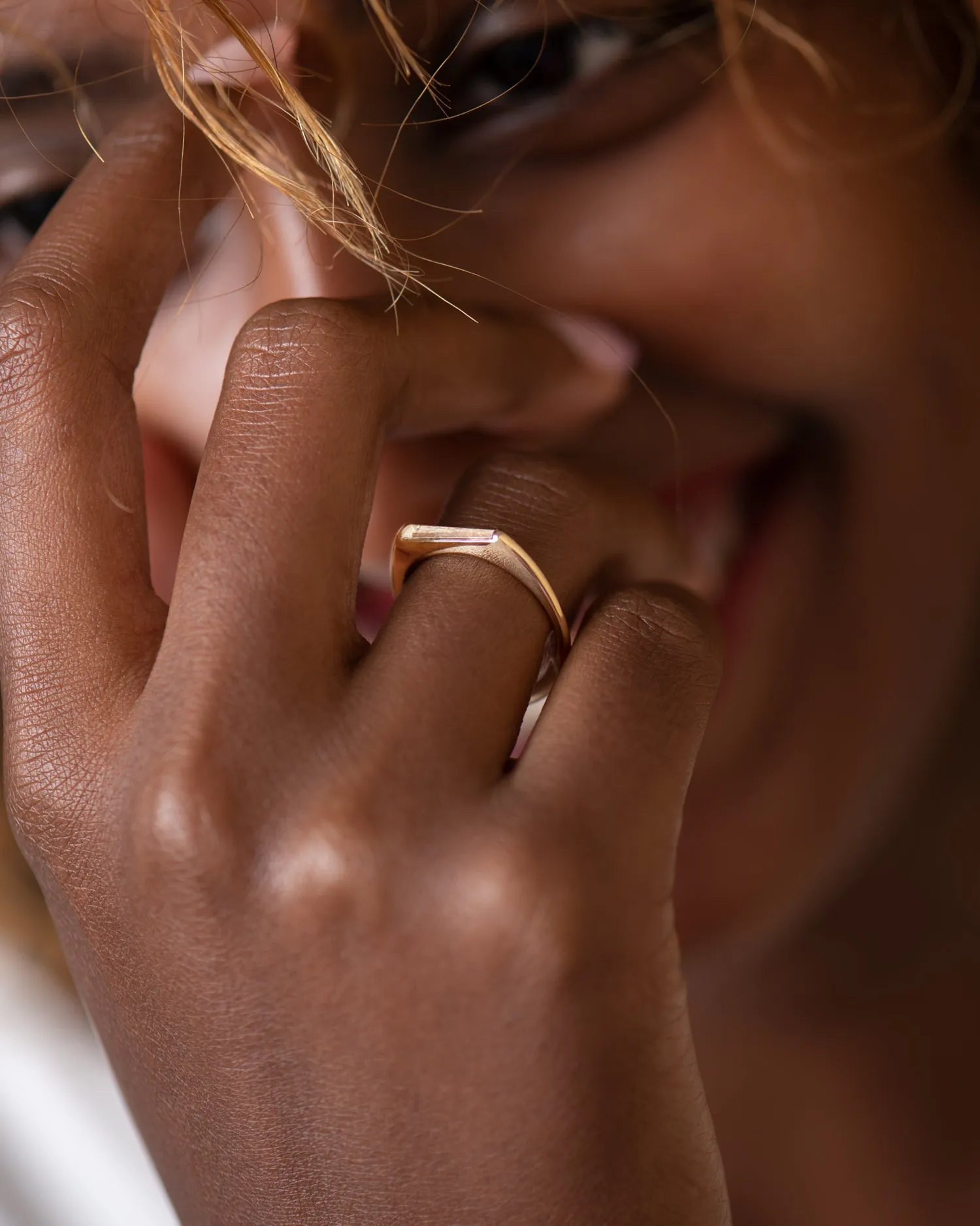 Tapered Baguette Solitaire Engagement Ring with a Modern Golden Bezel