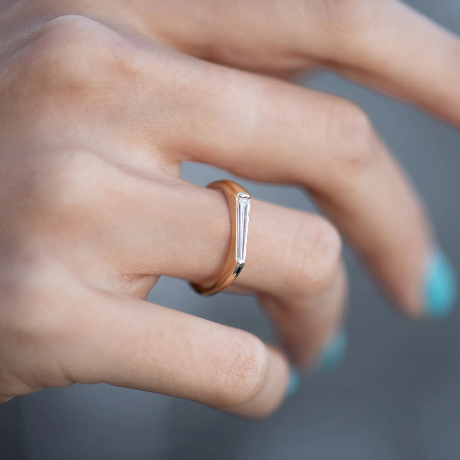 Tapered Baguette Solitaire Engagement Ring with a Modern Golden Bezel